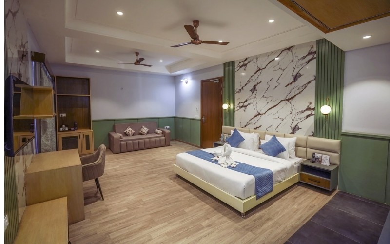 Deluxe Room — king bed, lounge sofa and work desk