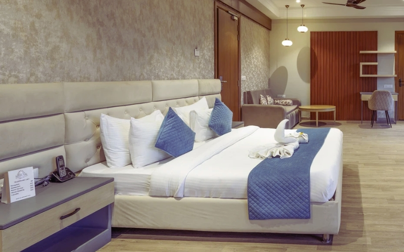 Premium Room — king bed with tufted headboard, sitting area and work desk